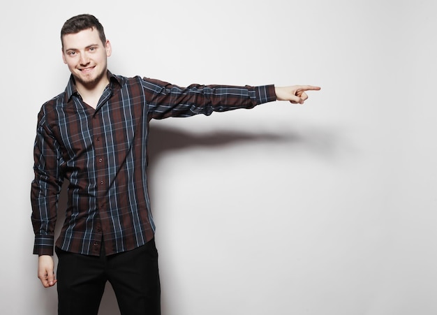 Photo life style  and people concept: handsome young man in shirt looking at camera