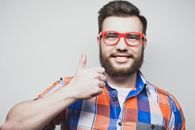 Life style and people concept: happy man giving thumbs up sign