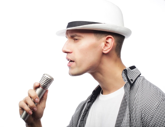 Life style and people concept: young singer man with microphone