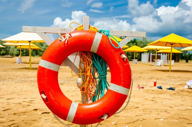 A lifebuoy on the beach by the sea in summer.