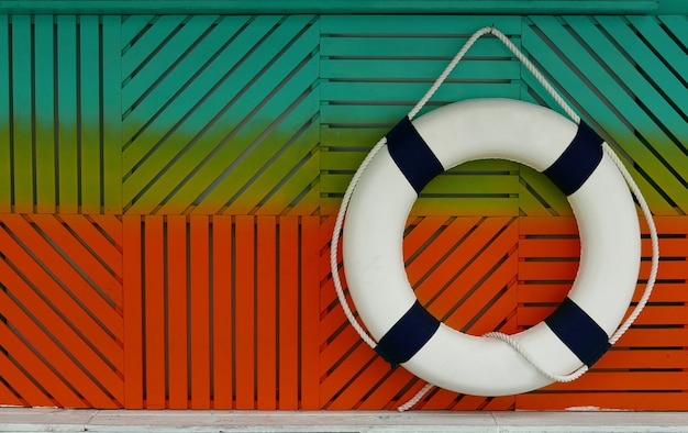 Lifebuoy on colorful wooden background