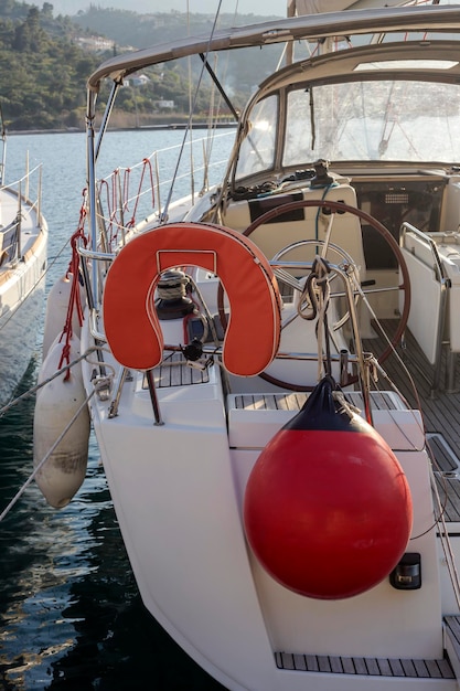 The lifebuoy in the form of a horseshoe and mooring fender closeup