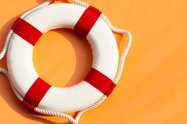 Lifebuoy on orange background Copy space