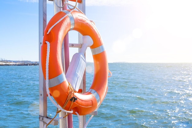 Lifebuoy on the pier on the background of the sea on a sunny day