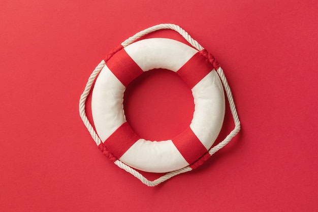 Photo lifebuoy on a red background top view