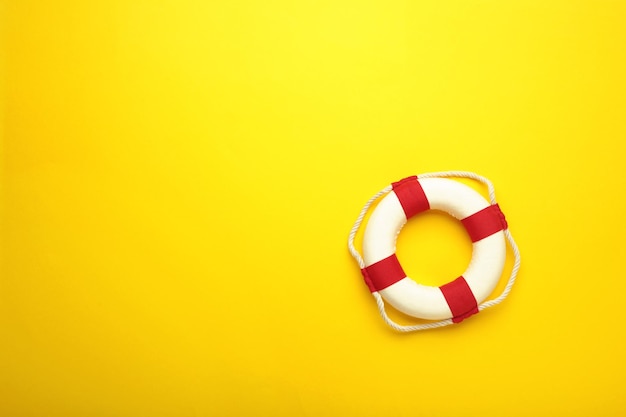 Lifebuoy on yellow background with copy space