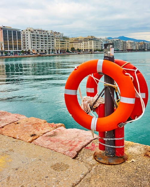 Lifebuoys on wharf in Thessaloniki and Nikis Avenue in the background. Greece