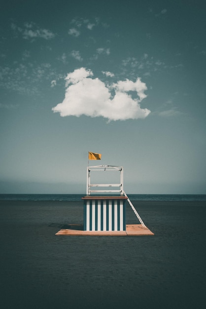 Lifeguard hut at beach against blue sky