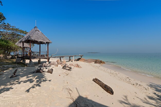 Lifeguard hut on beach against clear blue sky