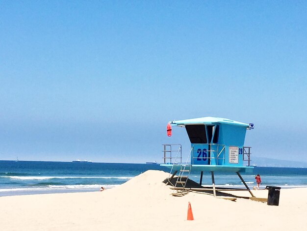 Lifeguard hut on beach against clear sky