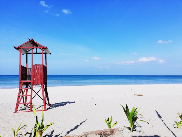 Lifeguard hut on beach against sky