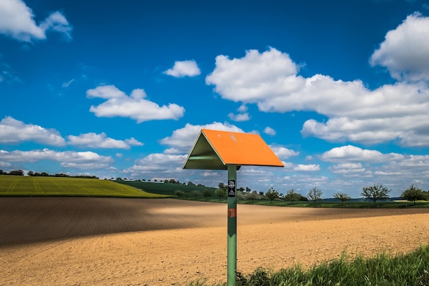 Lifeguard hut on field against sky