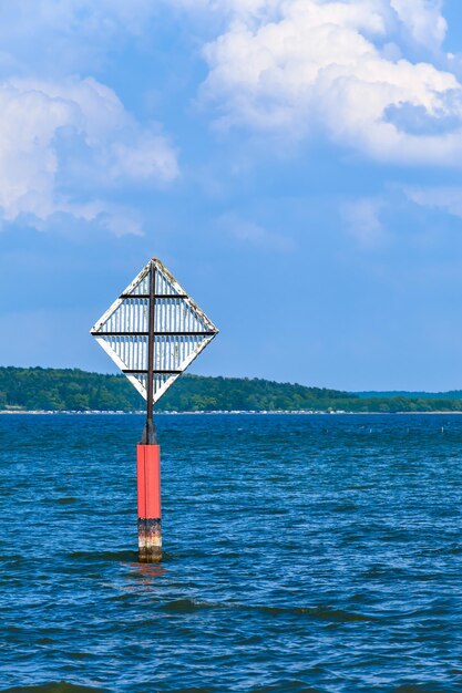 Lifeguard hut on sea against blue sky