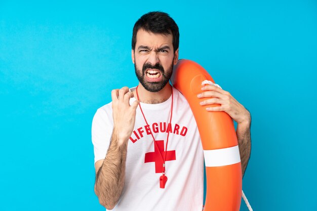 Lifeguard man over isolated blue wall frustrated by a bad situation