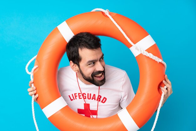 Lifeguard man over isolated blue wall