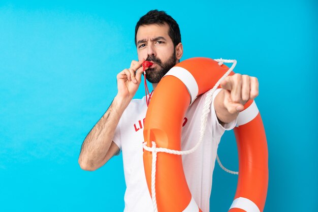 Lifeguard man over isolated blue wall