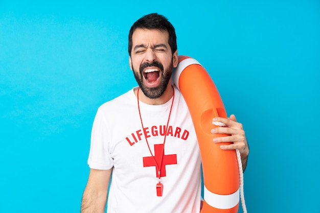 Lifeguard man shouting to the front with mouth wide open