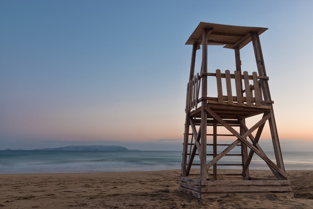 A lifeguard tower on the mediterranean beach at sunset during the summer