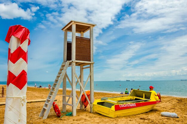 Lifeguard tower with a boat near the sea.