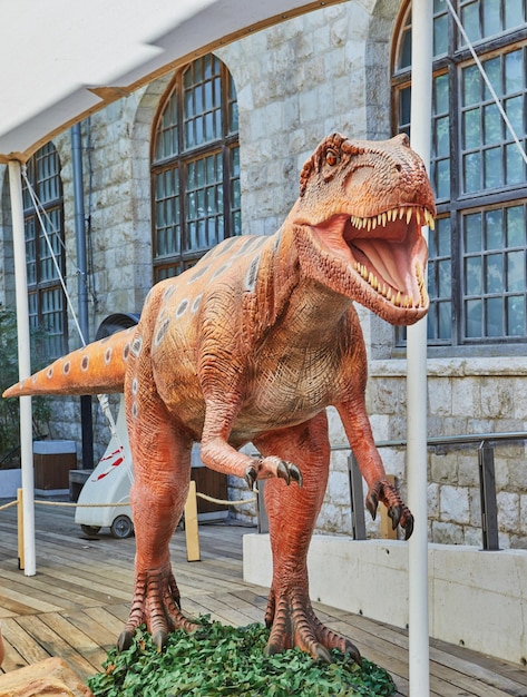 Lifesize dinosaur figure in the park is an approximation to reality