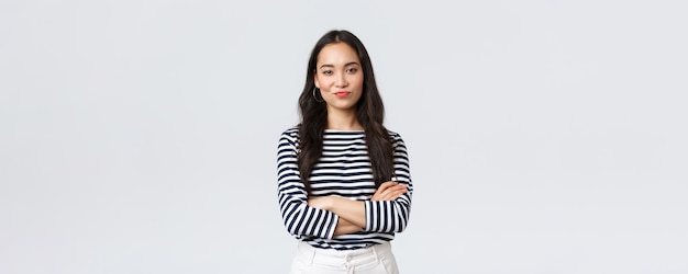 Lifestyle beauty and fashion people emotions concept Skeptical and judgemental asian female office manager looking picky smirk and pouting dissatisfied cross arms chest