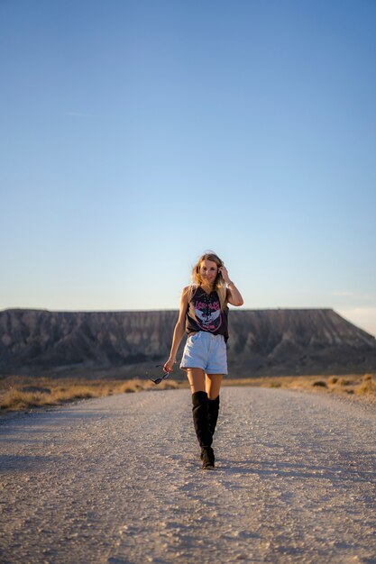 Lifestyle, a blonde Caucasian woman walking through a beautiful desert