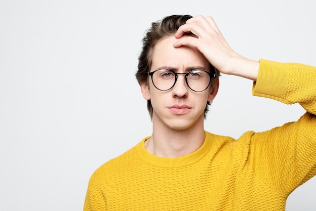 Lifestyle and body language concept Handsome young man wearing eyewear suffering from headache