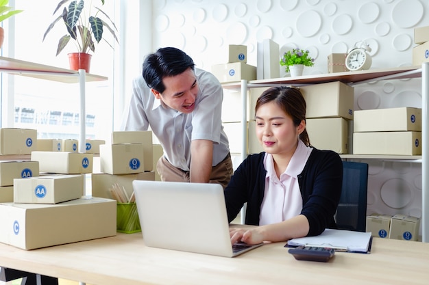 Lifestyle business couple sitting in office looking screen laptop happy working , SME small business