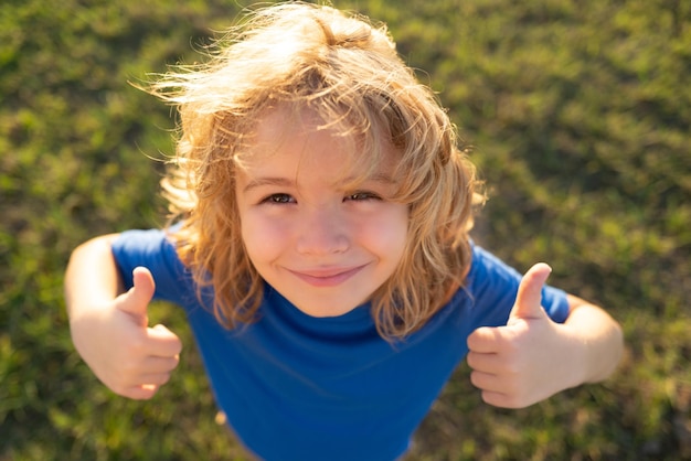 Lifestyle closeup portrait of funny kids face outdoors summer kid outdoor portrait close up face of