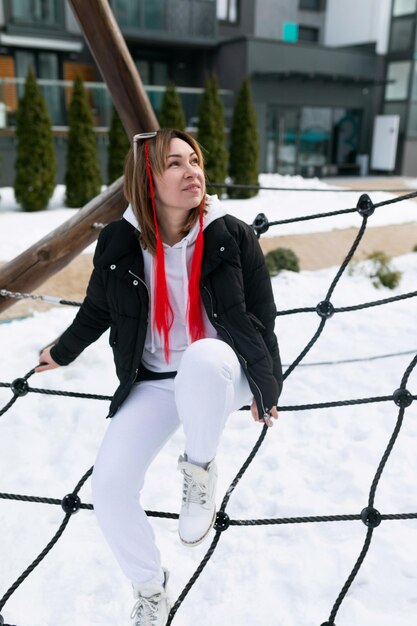 Lifestyle concept caucasian woman walking on the playground in the cold