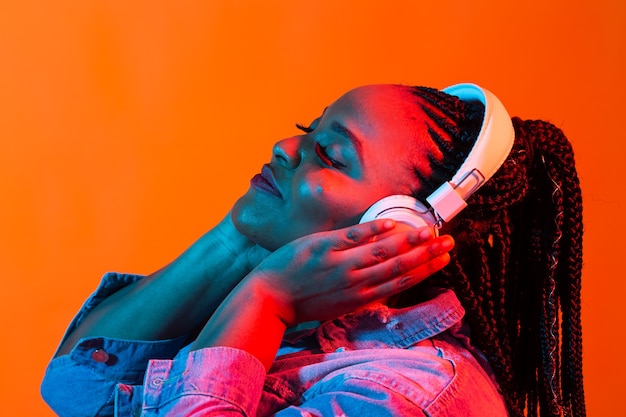 Lifestyle concept - Portrait of beautiful African American woman joyful listening to music.