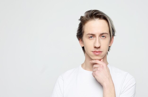 Lifestyle emotion and people concept handsome young man wear white tshirt looking at camera