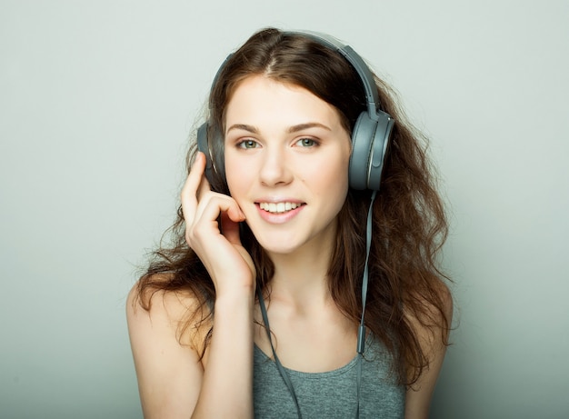 Lifestyle en mensen concept: jonge gelukkige vrouw met koptelefoon luisteren muziek.