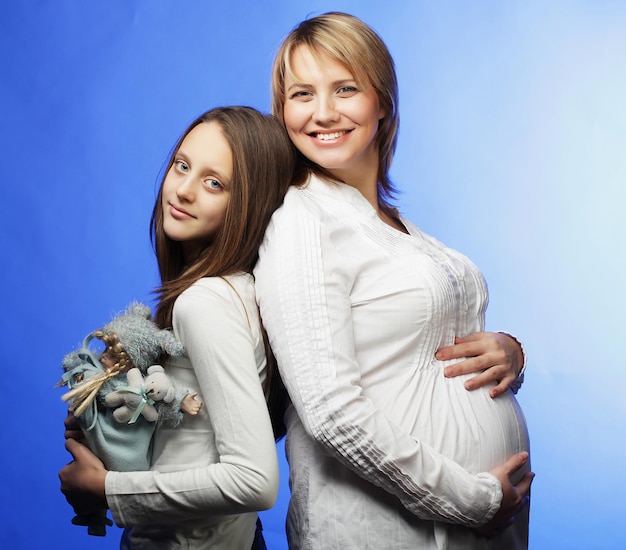 Lifestyle family and people concept pregnant young woman and her eldest daughter close up