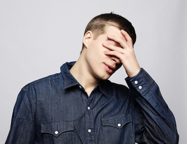 lifestyle health and people concept Handsome young man suffering from headache close up
