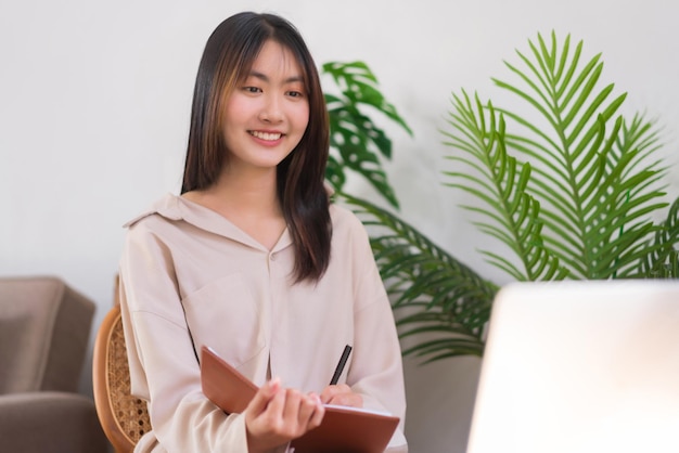 Lifestyle at home concept Young Asian woman thoughtful new project of business and taking notes