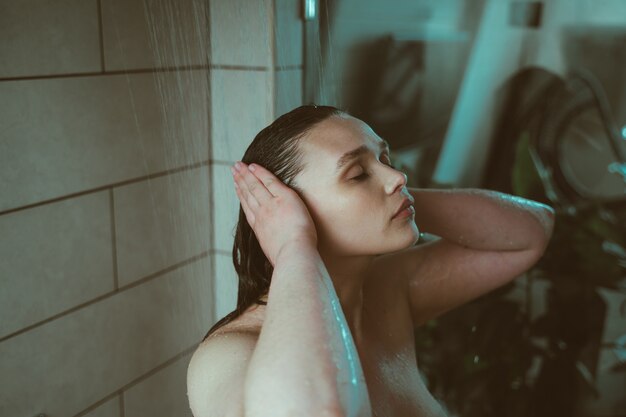 Lifestyle moments of a young woman at home Woman taking a shower in the morning