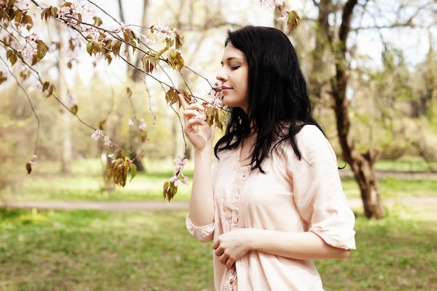 Lifestyle and people concept Beautiful young woman in blossom garden Sakura and spring