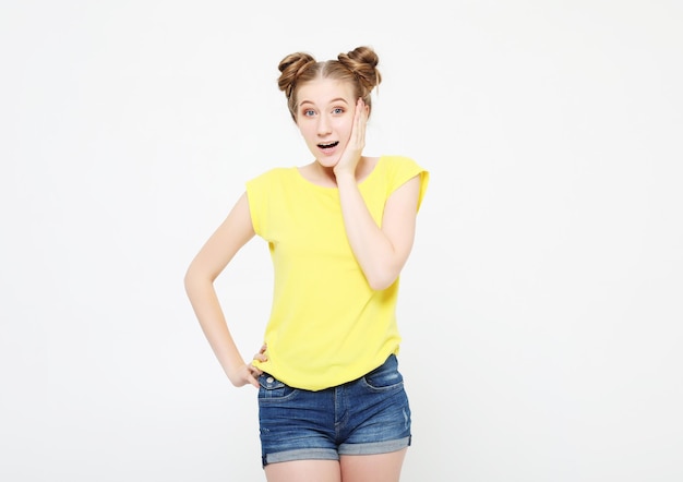 Lifestyle and people concept Image of excited screaming young woman standing isolated over white background