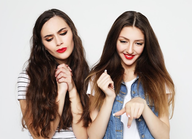 Lifestyle and people concept Two young girl friends standing together and having fun