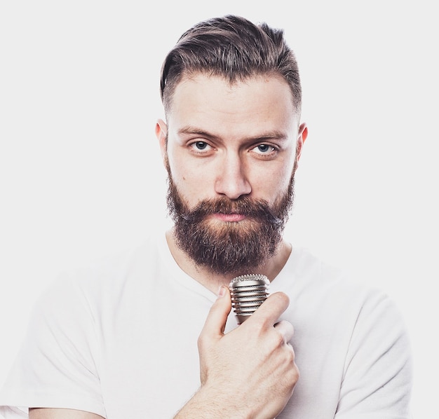 Lifestyle and people concept young bearded man singing with microphone