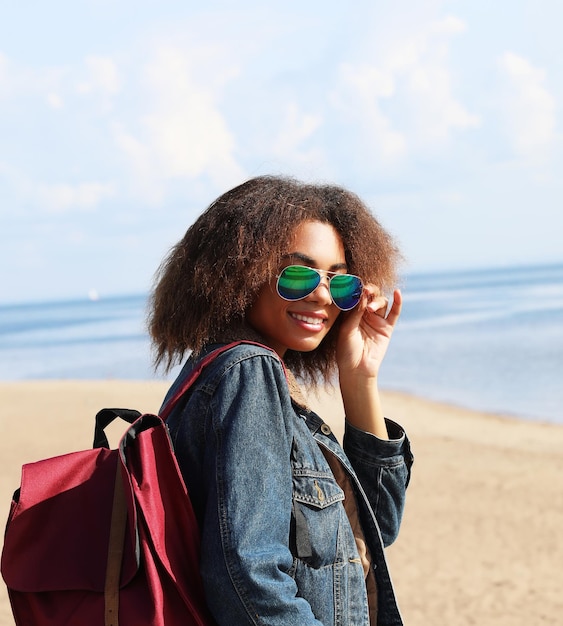 Lifestyle and people concept Young black woman with backpack on the street