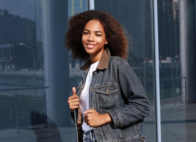 Lifestyle and people concept Young black woman with backpack on thu street