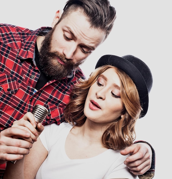 Lifestyle and people concept Young couple with microphone