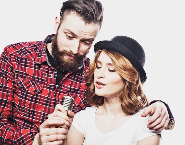 Lifestyle and people concept Young couple with microphone