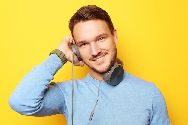 Lifestyle and people concept young man listening to music with