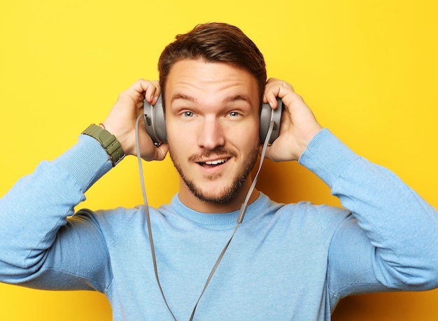 Lifestyle and people concept young man listening to music with