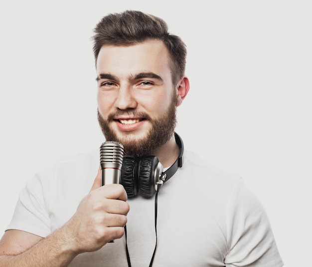 Lifestyle and people concept young man singing with microphone