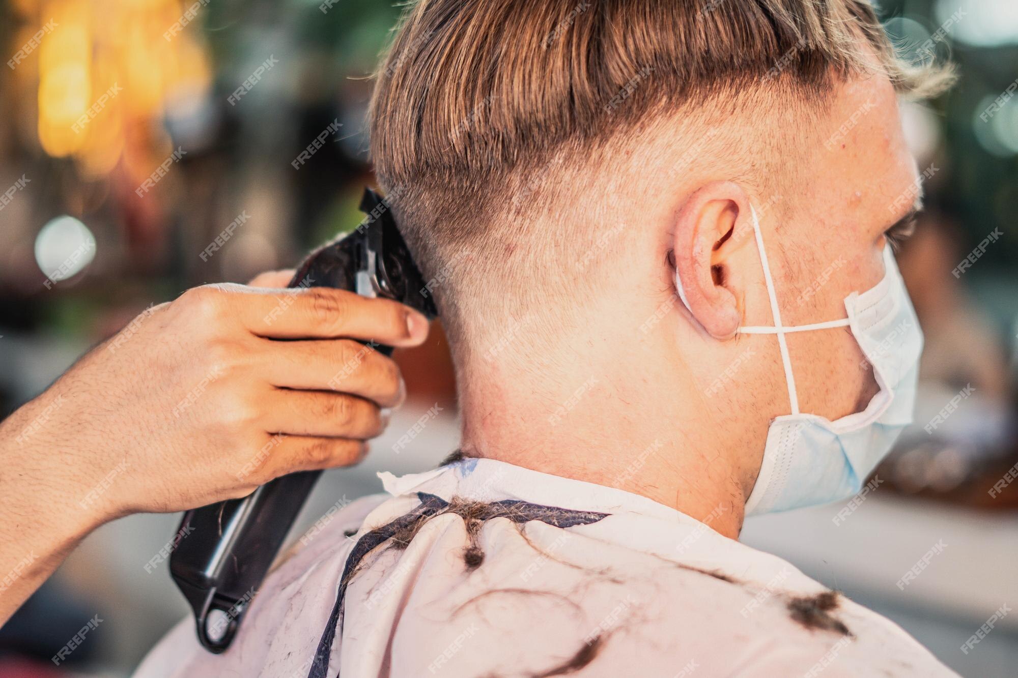 Premium Photo | Lifestyle photo barbershop young man customer wears face mask side back rear view hairdresser male hand work move comb tool electric clipper modern short hair locks cut fashion service Premium Photo | Lifestyle photo barbershop young man customer wears face mask side back rear view hairdresser male hand work move comb tool electric clipper modern short hair locks cut fashion service