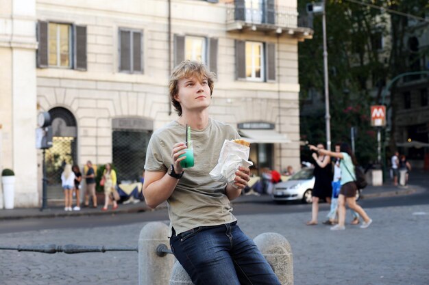 Lifestyle portrait of a young man relaxing and having lunch